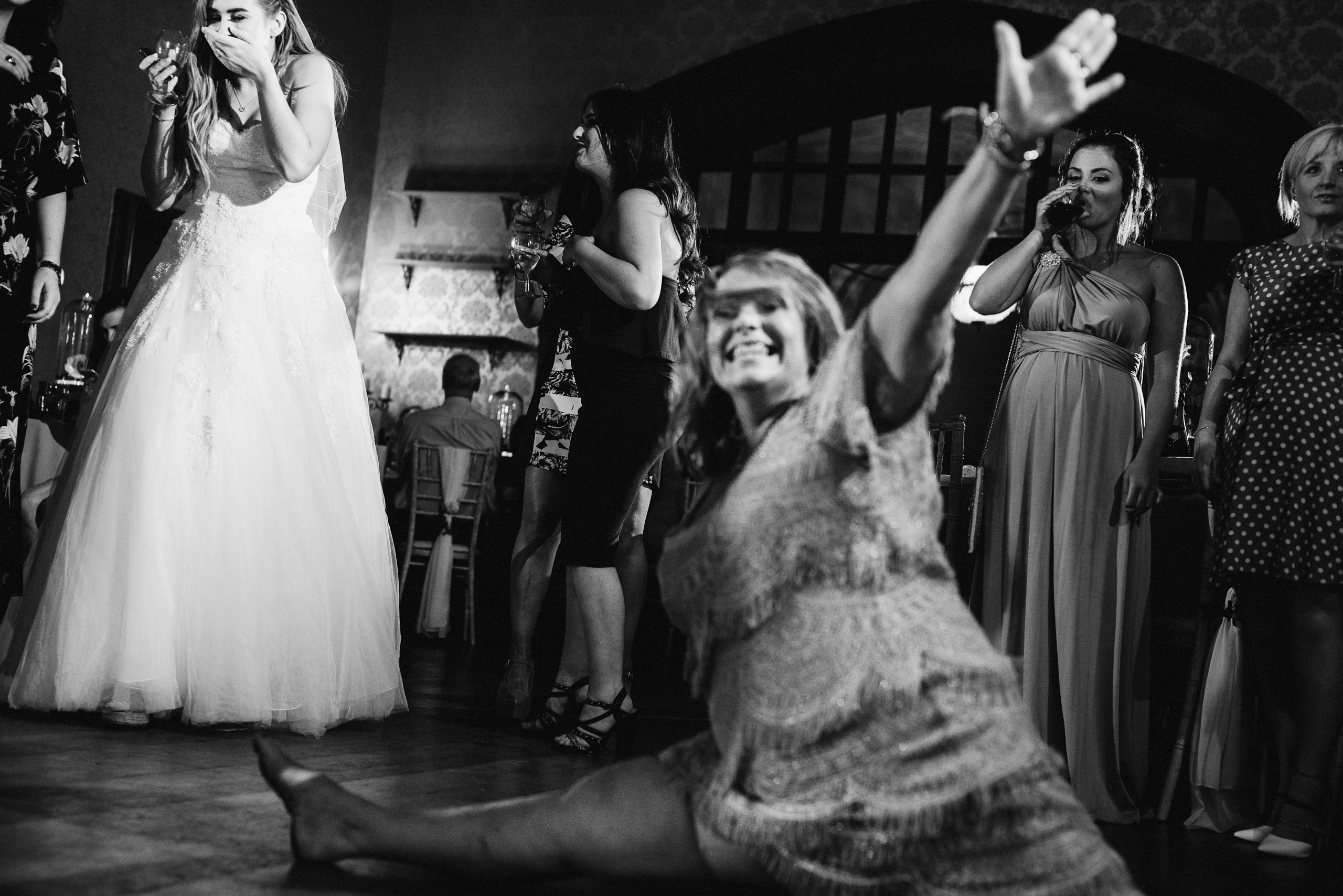 Mother of the bride doing the splits at the wedding party