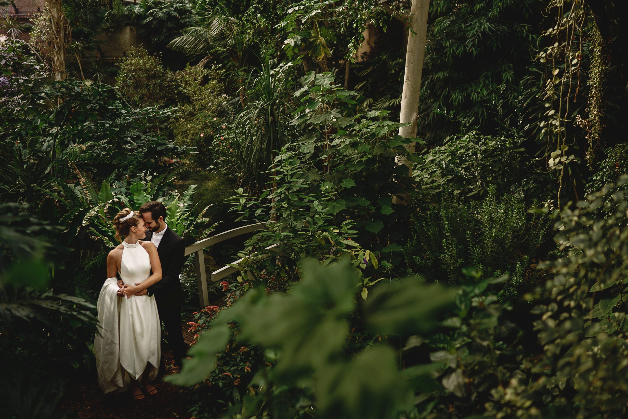Bride and groom in the barbican conservatory