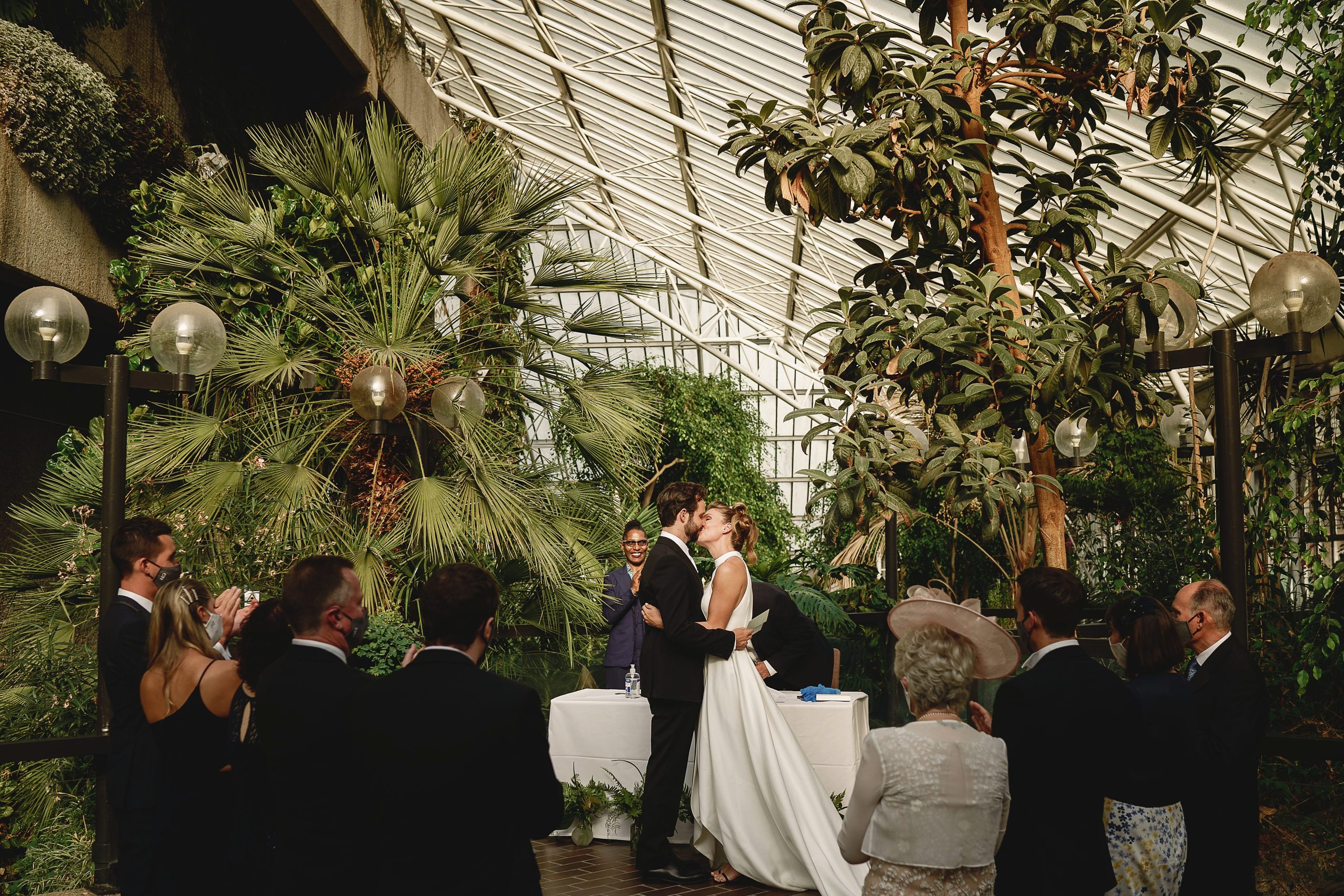 Bride and groom first kiss at the barbican conservatory