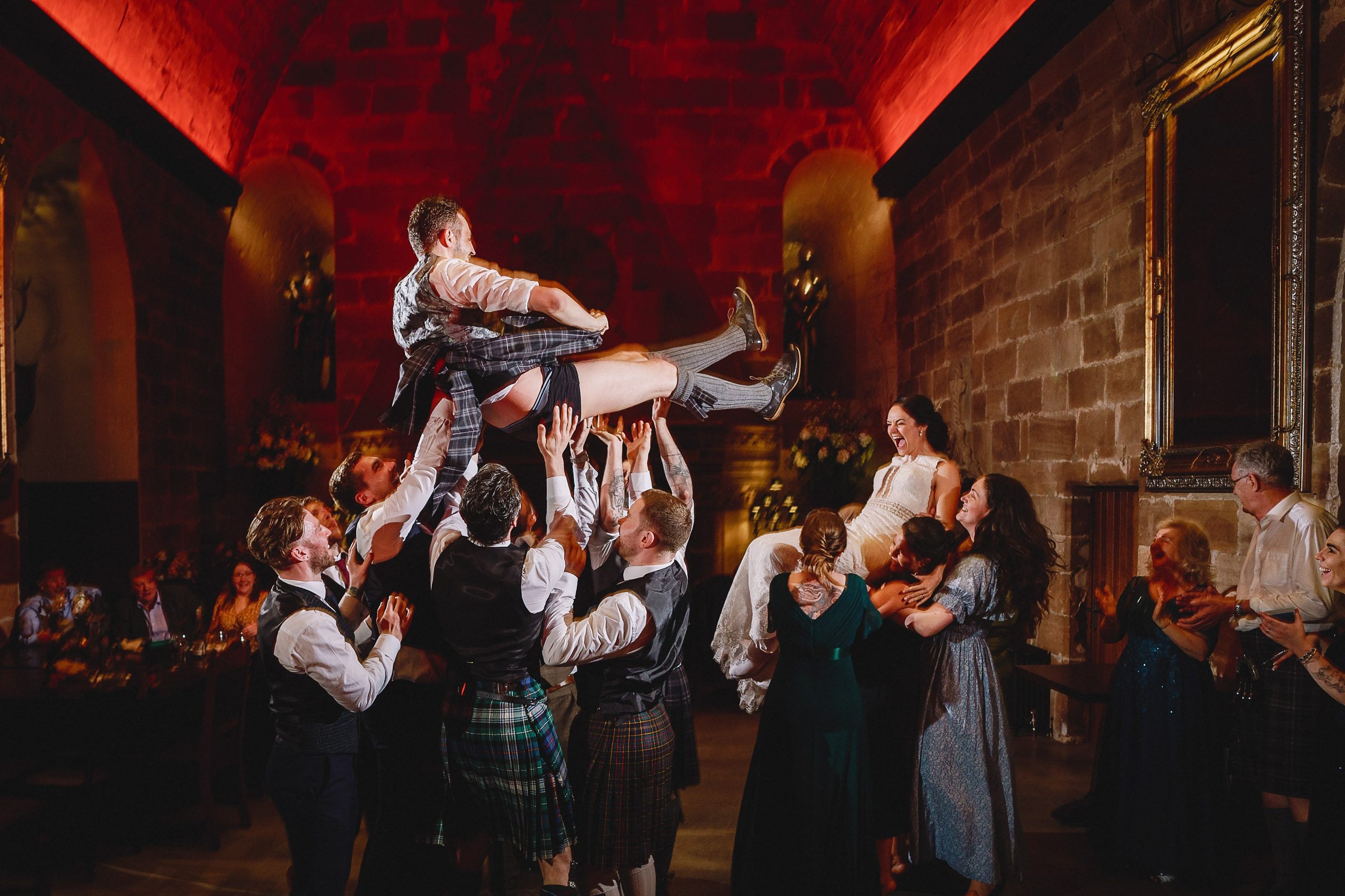 Groom being thrown in the air on the dance  floor borthwick castle wedding