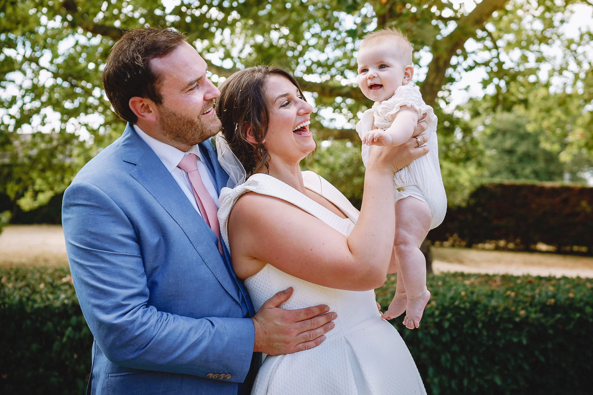 Bride and groom with baby at Chateau Rigaud wedding