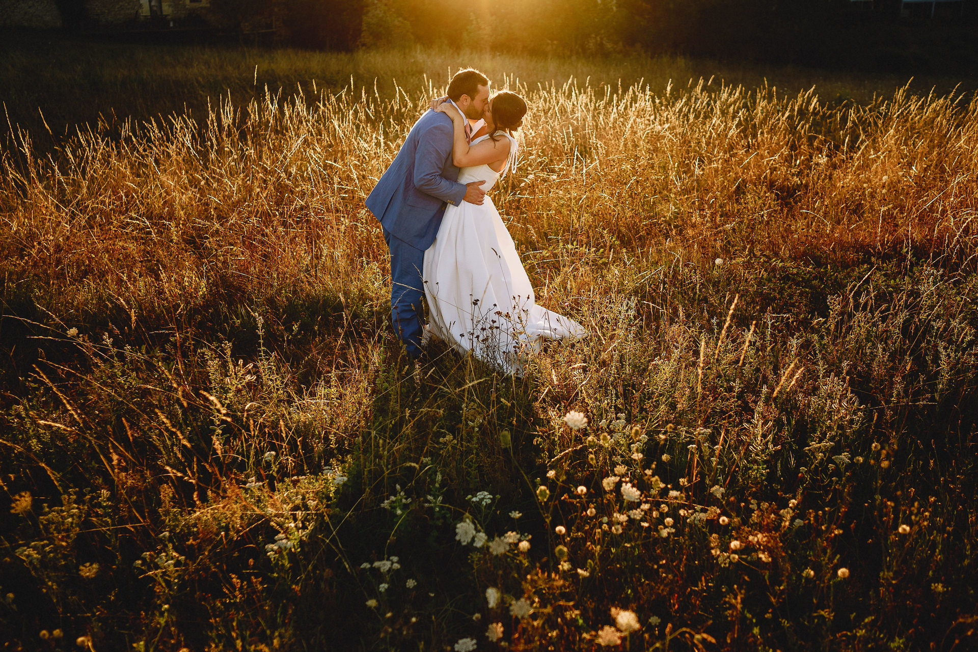Bride and groom as the sunsets in a field at Chateau Rigaud