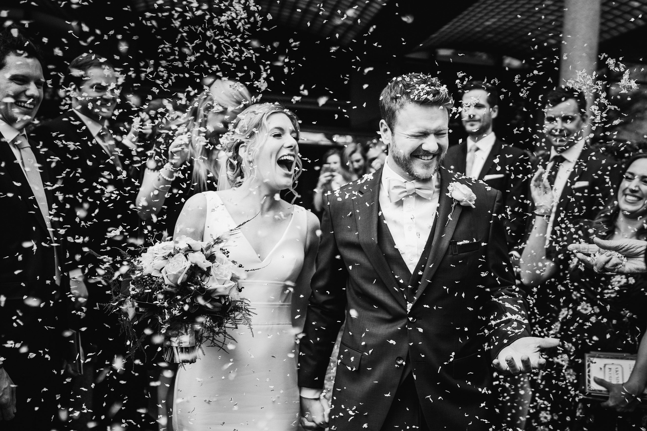 Bride and groom exiting wedding ceremony and covered in confetti yorkshire wedding photographer
