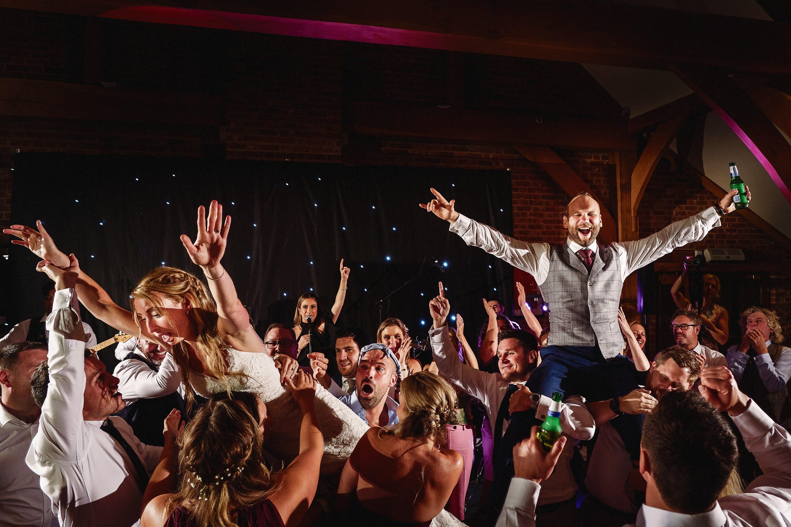 Bride and groom on guests shoulders at wedding party yorkshire photography